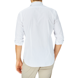 Man standing with his back to the camera wearing a Xacus White Cotton Twill Tailor Fit Shirt and beige pants.