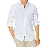 Man wearing a Xacus White Cotton Twill Tailor Fit Shirt and beige pants.