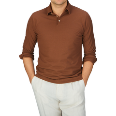 A man wearing a Zanone Coffee Brown Ice Cotton LS Polo Shirt and white pants.