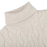 Close-up of the Ecru Beige Wool Cable Knit Rollneck by Zanone, made from pure virgin wool, lying flat on a white surface.