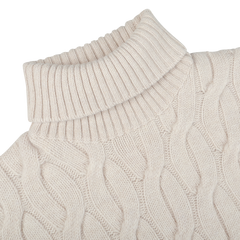 Close-up of the Ecru Beige Wool Cable Knit Rollneck by Zanone, made from pure virgin wool, lying flat on a white surface.