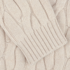 Close-up of the Ecru Beige Wool Cable Knit Rollneck by Zanone, showcasing its chunky cable-knit fabric made from virgin wool with detailed patterns and textures.