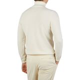 The back view of a man wearing an Ecru Beige Wool Cashmere Zanone rollneck sweater.