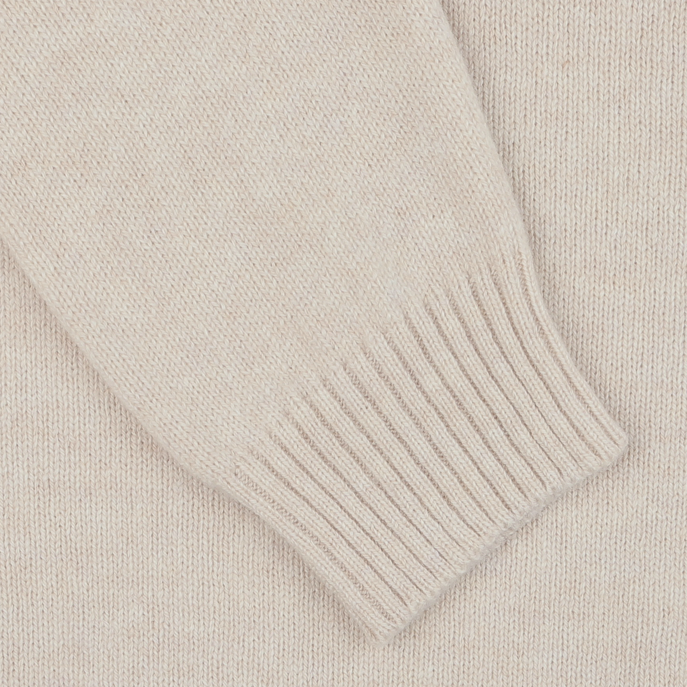 Close-up of a sleeve from the Zanone Ecru Beige Wool Winter LS Polo Shirt, showcasing a ribbed cuff, crafted from pure virgin wool.