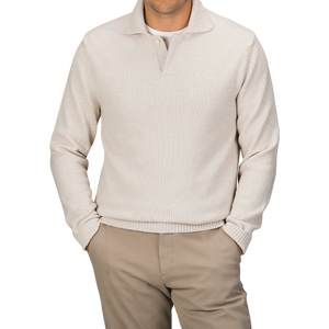 A person wearing an Ecru Beige Wool Winter LS Polo Shirt by Zanone, featuring a regular fit and long sleeves made of pure virgin wool, paired with beige pants and both hands in their pockets.