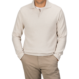 A person wearing an Ecru Beige Wool Winter LS Polo Shirt by Zanone, featuring a regular fit and long sleeves made of pure virgin wool, paired with beige pants and both hands in their pockets.