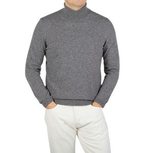 A Zanone knitwear specialist wearing a Grey Melange Wool Cashmere Rollneck sweater and white pants.