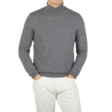 A Zanone knitwear specialist wearing a Grey Melange Wool Cashmere Rollneck sweater and white pants.