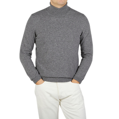 A Zanone knitwear specialist wearing a Grey Melange Wool Cashmere Rollneck sweater and white pants.