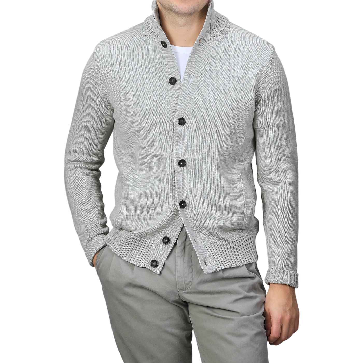 A person elegantly wears the Light Grey Merino Wool Button Cardigan by Zanone, draped over a white shirt and gray pants, with hands casually tucked in their pockets.