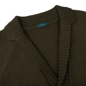 A Zanone Military Green Wool Shawl Collar Cardigan with a green label.