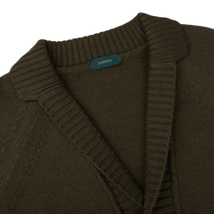 A Zanone Military Green Wool Shawl Collar Cardigan with a green label.