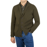 A man wearing a Zanone military green wool shawl collar cardigan and jeans.