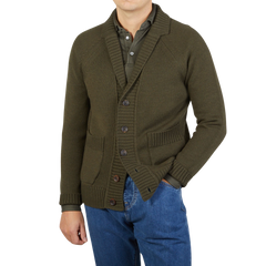 A man wearing a Zanone military green wool shawl collar cardigan and jeans.