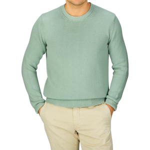 A man wearing a Aqua Green Cotton Crew Neck Sweater and tan pants by Zanone.
