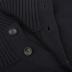 This close-up encapsulates the essence of the Navy Blue Merino Wool Button Cardigan by Zanone, highlighting its luxurious merino wool fabric, two visible black buttons, and ribbed texture along the collar and buttonholes.