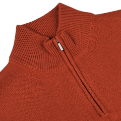 Close-up image of Zanone's Rust Red Wool Quarter Zip Sweater featuring a partially open zipper that reveals the ribbed texture of its virgin wool fabric.