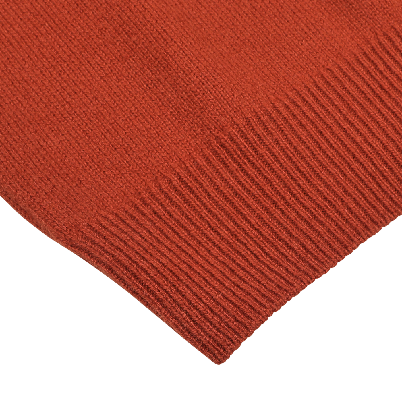 Close-up of the corner of a rust red knitted fabric with ribbed edging, most likely part of the luxurious Rust Red Wool Quarter Zip Sweater by Zanone.