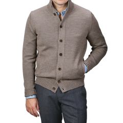 A man wearing a Zanone Taupe Beige Merino Wool Button Cardigan over a blue shirt with gray pants.