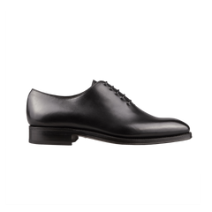 Carmina's Black Calf Leather Wholecut Rain Oxford Shoes, featuring smooth leather and laces, are showcased from the side against a solid black background. These shoes boast Goodyear welted construction, ensuring unparalleled durability and elegance.