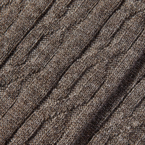 A close up image of brown cable knitted cashmere socks made with pure cashmere thread by Bresciani.
