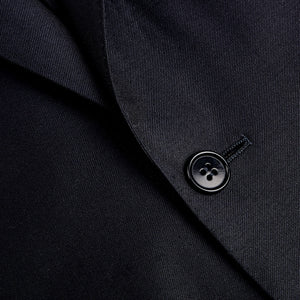 A close up of a button on a Canali Navy Blue Wool Notch Lapel Suit.