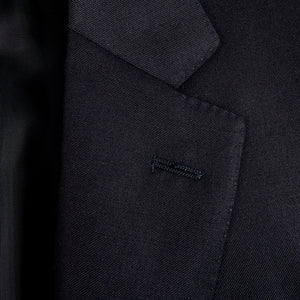 A close up of a Canali Navy Blue Wool Notch Lapel Suit with a structured shoulder and formal button.