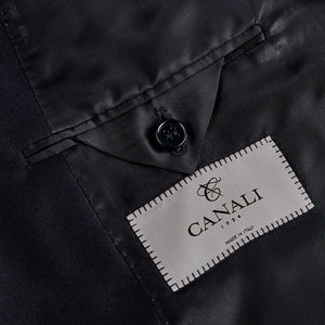 A close up of the label on a Canali Navy Blue Wool Notch Lapel Suit showcasing classic sartorial elegance.