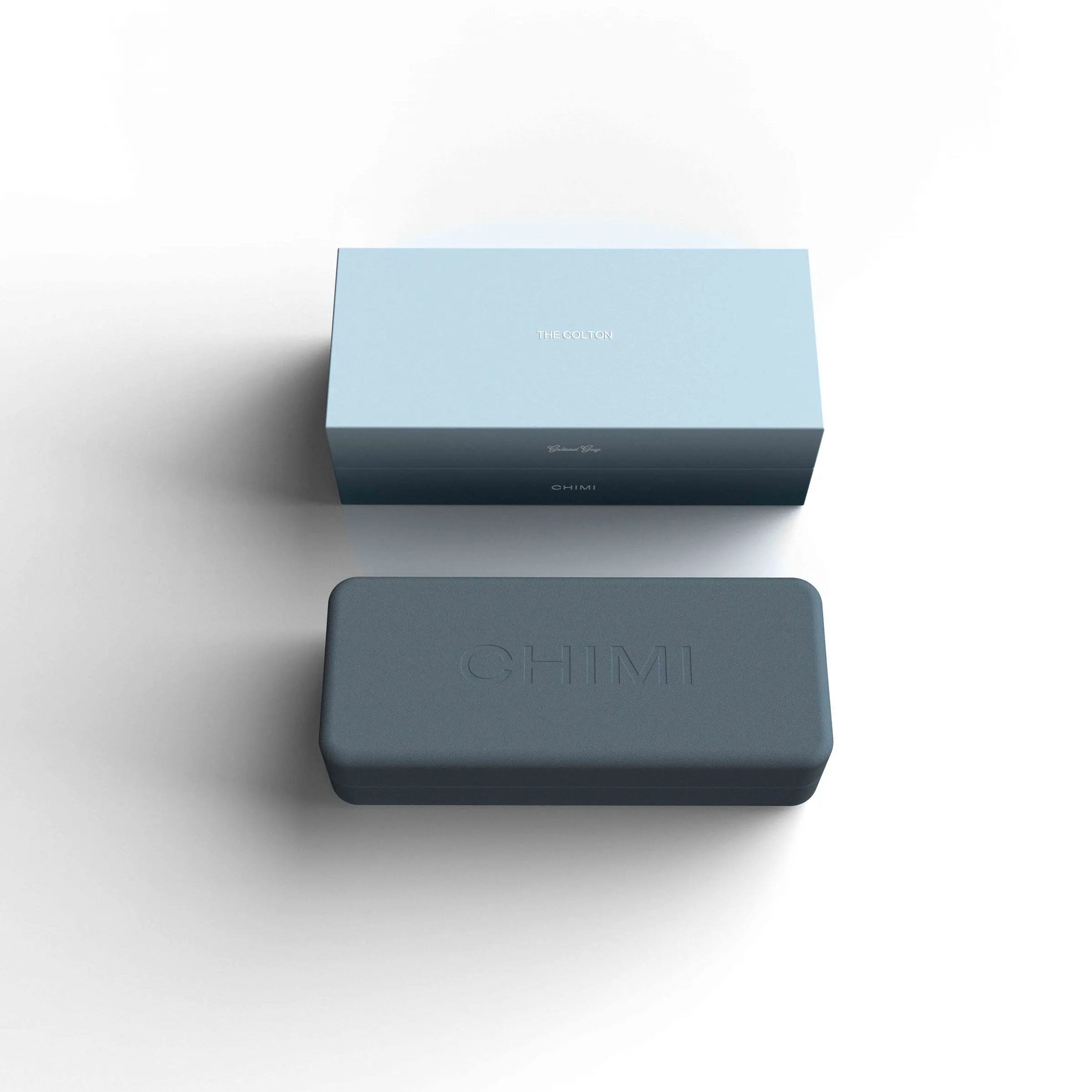 A minimalist silhouette of a Dark Blue The Colton Gstaad Guy Sunglasses box with the words Chimi on it.