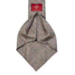 A Brown Checked 7-Fold Vintage Wool Tie by Dreaming Of Monday on a grey background.