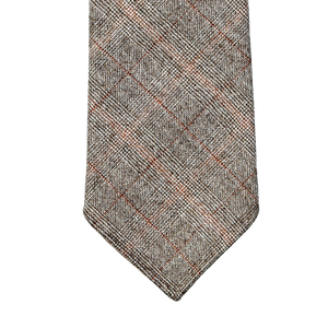 A gray and brown plaid Dreaming Of Monday handmade tie on a gray background.