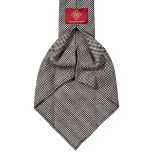A handmade Dreaming Of Monday Brown Houndstooth 7-Fold Vintage Wool Tie on a white background.
