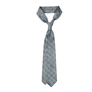 A Dreaming Of Monday grey checked 7-fold vintage wool tie on a white background.