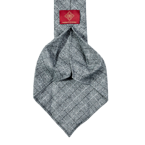 A Dreaming Of Monday 7-Fold Vintage Wool Tie with unlined construction featuring a Gray Checked pattern and a red label.