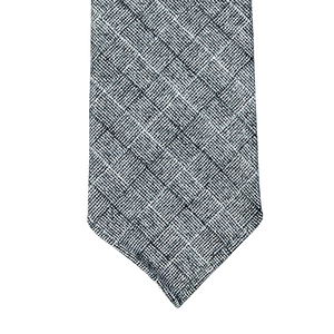 A Grey Checked 7-Fold Vintage Wool Tie by Dreaming Of Monday on a gray background, handmade in Sweden.