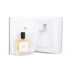 An Eight Bob Perfume Original 100 ml Inside Book rests on an open book.