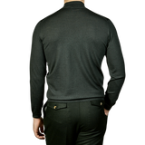 The back view of a man wearing a Fedeli Green 140s Wool Mockneck Sweater.