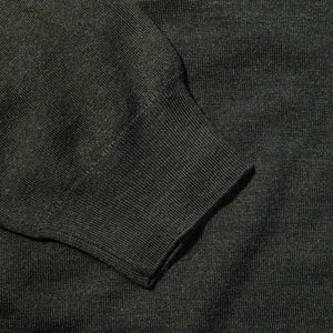 A practical and elegant close up of a Fedeli Green 140s Wool Mockneck Sweater.