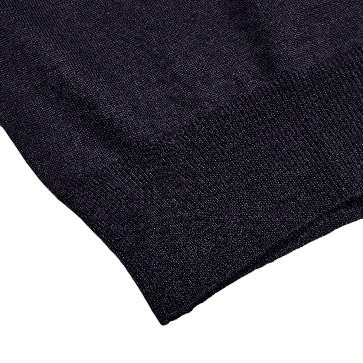 A close up of a Fedeli Navy 140s Wool Mockneck Sweater on a white surface.