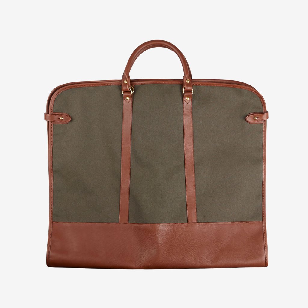 A Green Canvas Chestnut Leather Garment Bag made by Frank Clegg, with leather specialist features, on a white background.