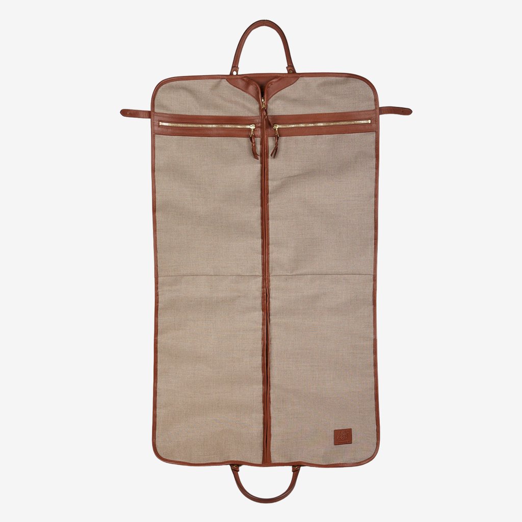 A Green Canvas Chestnut Leather Frank Clegg garment bag with brown handles.