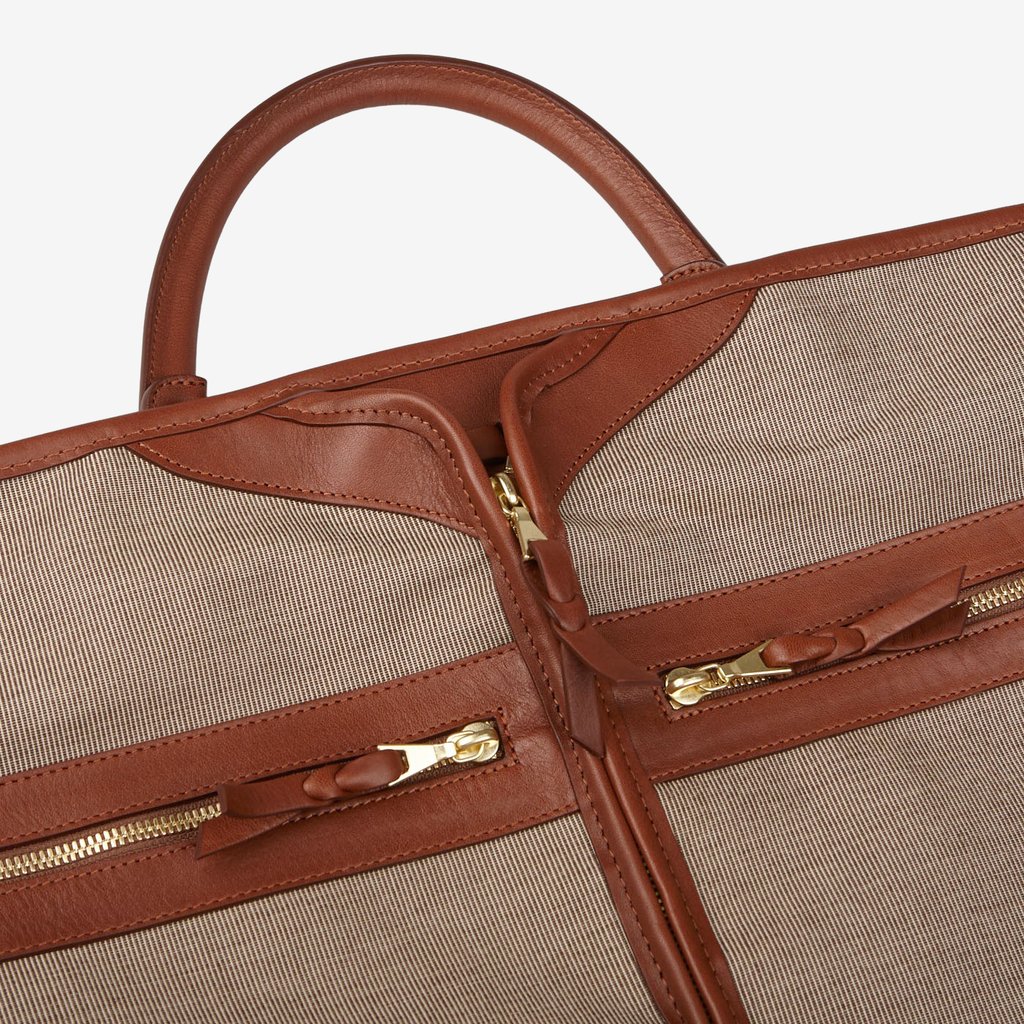 A Frank Clegg Green Canvas Chestnut Leather Garment Bag.