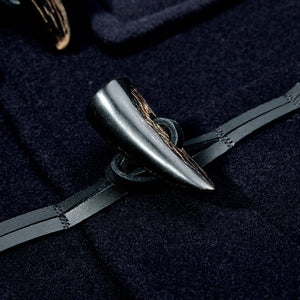A pair of cufflinks with buffalo horn toggles featuring a tiger's tooth from Gloverall Navy Blue Wool Morris Duffle Coat.