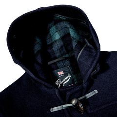 A Gloverall Navy Blue Wool Morris Duffle Coat with a plaid label on the hood, made of Italian wool.