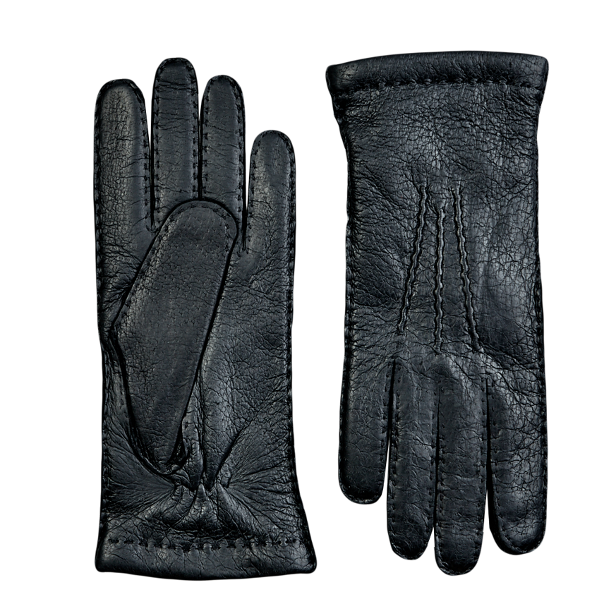 A pair of Hestra Black Cashmere Lined Peccary Handsewn Gloves on a grey surface.