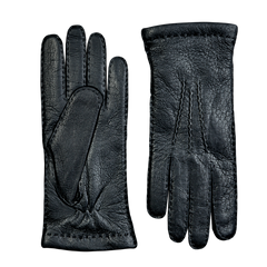 A pair of Hestra Black Cashmere Lined Peccary Handsewn Gloves on a grey surface.