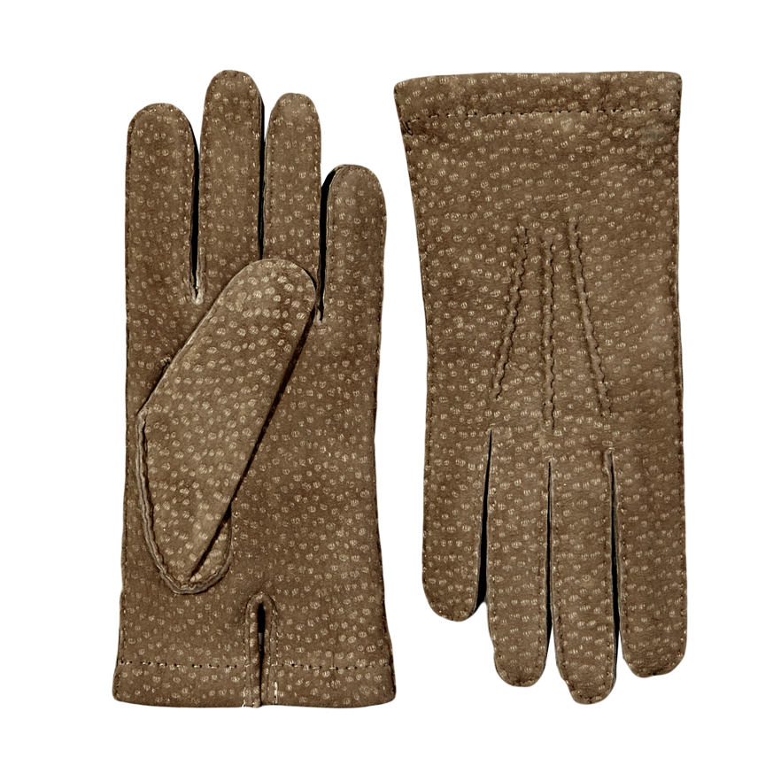 A pair of Hestra Camel Carpincho Handsewn Cashmere Gloves on a grey surface.