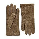 A pair of Hestra Camel Carpincho Handsewn Cashmere Gloves on a grey surface.