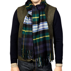 A man wearing a Navy Checked Dress Gordon Cashmere Scarf by Johnstons Of Elgin.