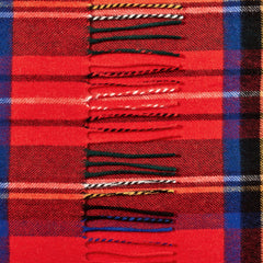 A close-up of the Johnstons Of Elgin Red Checked Royal Stewart Cashmere Scarf highlights its red tartan pattern with blue, black, and yellow stripes, complete with fringe along one edge.